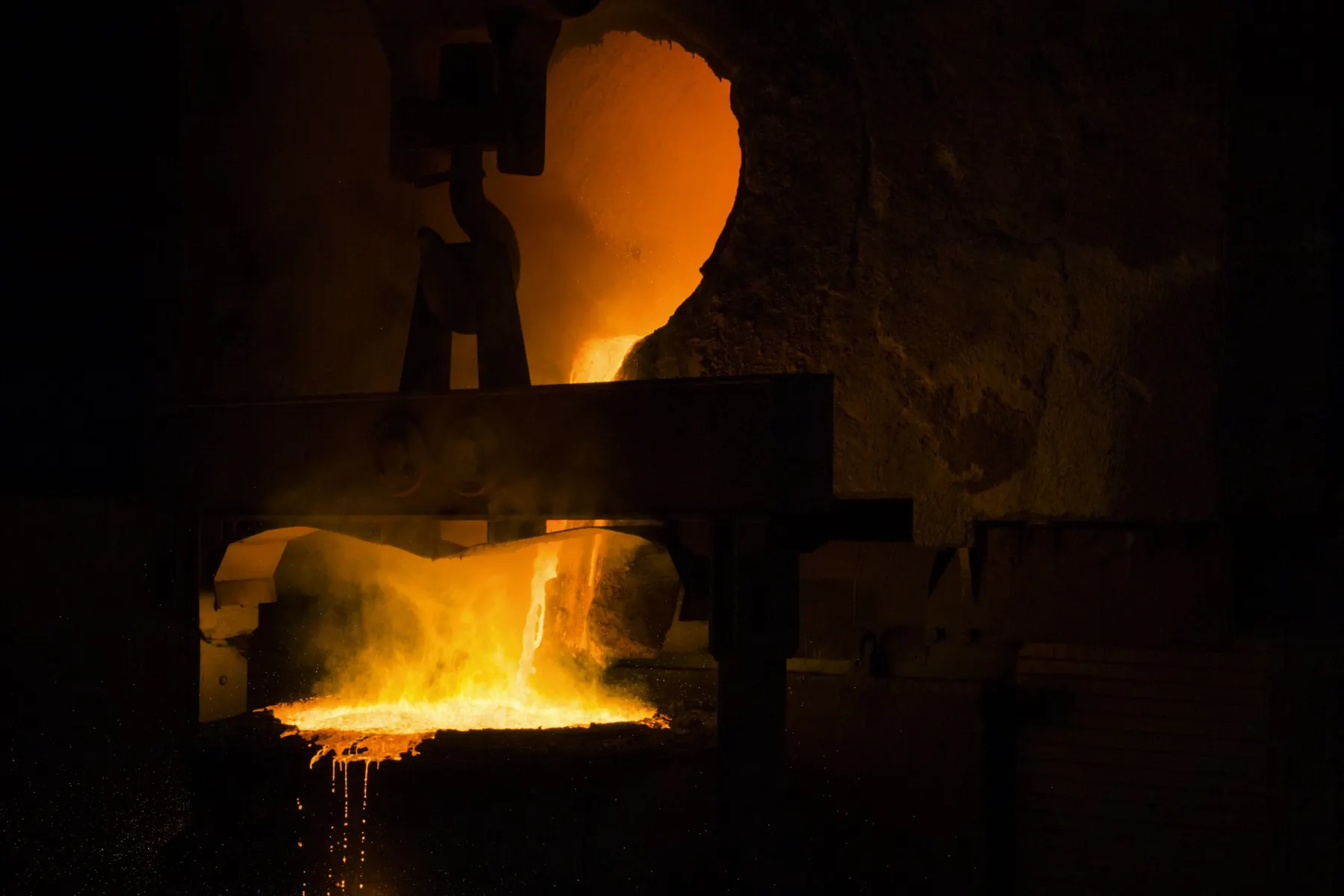 Molten material glowing inside an industrial furnace
