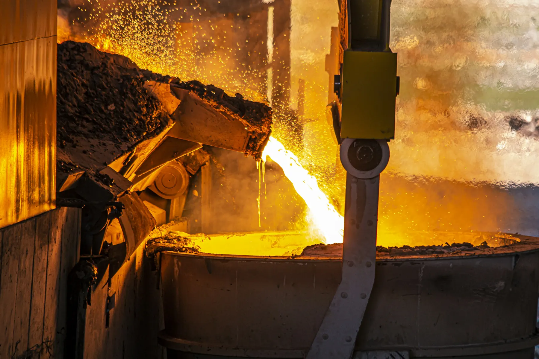 Molten metal pouring from a furnace into a ladle